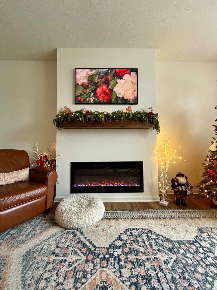 Fireplace built into a wall that had none, with an electric insert and a custom mantel